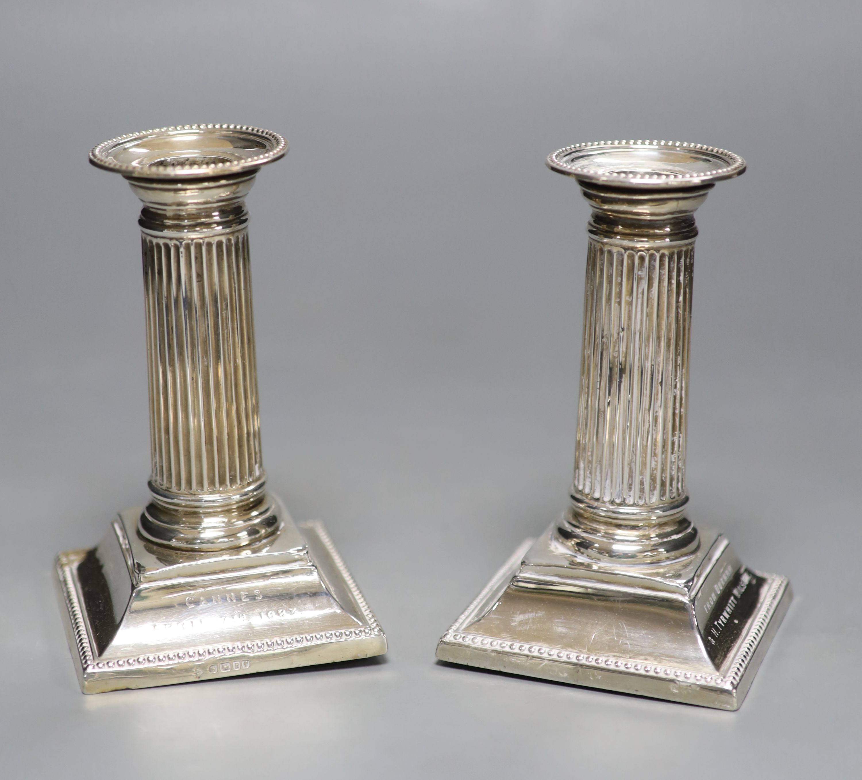 A pair of late Victorian silver dwarf candlesticks, with engraved inscriptions, Martin, Hall & Co, Sheffield, 1882, 12.9cm